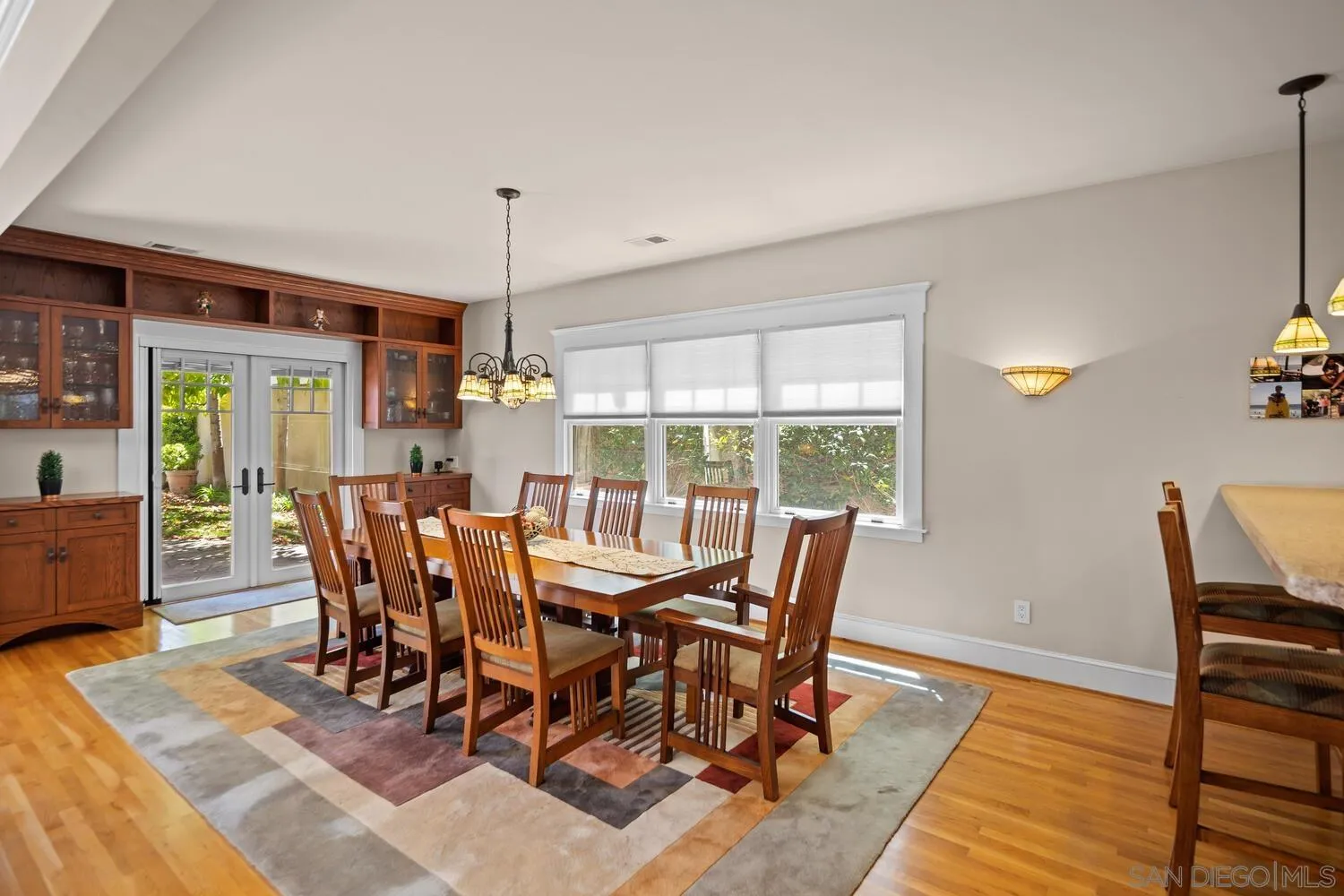 911 B Avenue Coronado, CA 92118 - Photo 12 of 45 a view of a dining room with furniture window and wooden floor