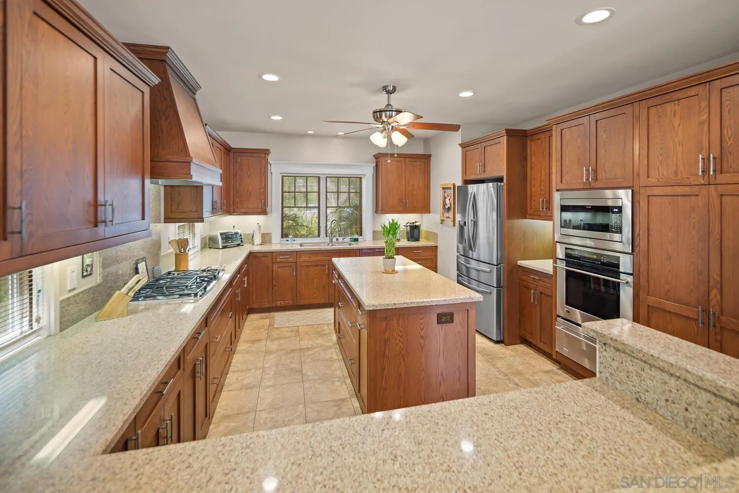 911 B Avenue Coronado, CA 92118 - Photo 16 of 45 a large kitchen with stainless steel appliances kitchen island granite countertop a large counter top stainless steel appliances and cabinets