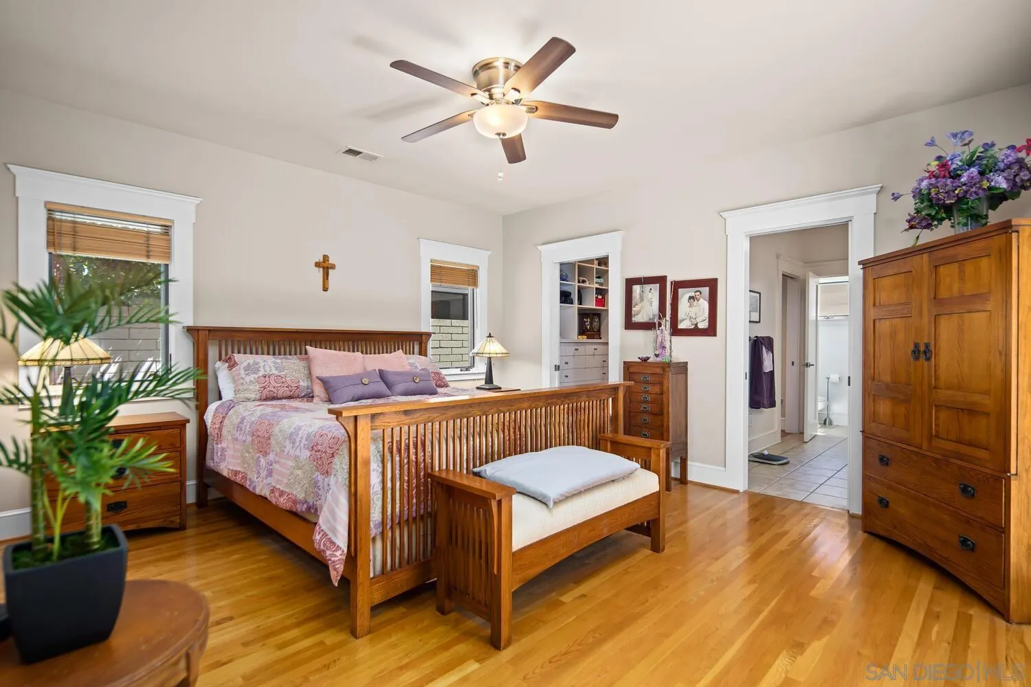 911 B Avenue Coronado, CA 92118 - Photo 19 of 45 a spacious bedroom with a bed and a chandelier