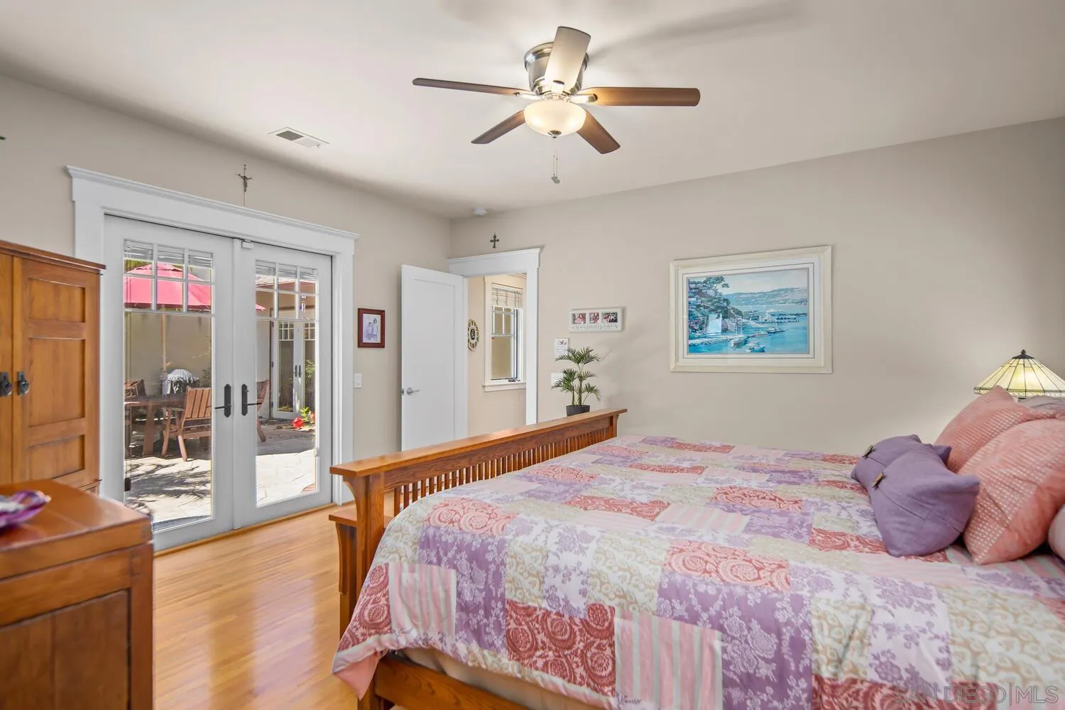 911 B Avenue Coronado, CA 92118 - Photo 20 of 45 a bedroom with a large bed and a chandelier