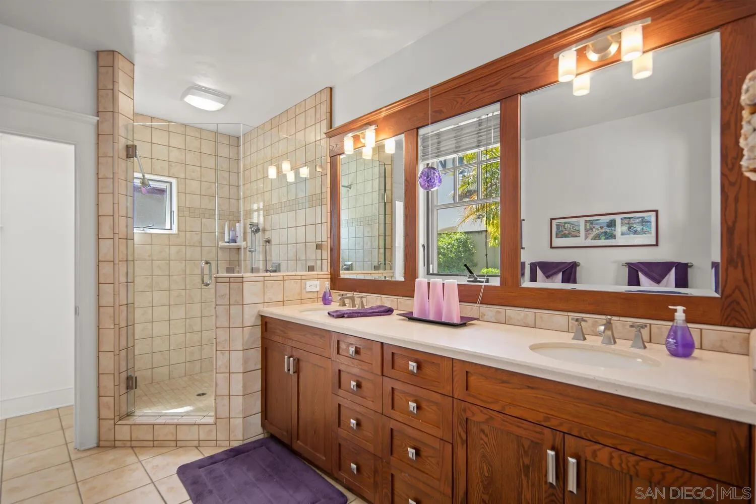 911 B Avenue Coronado, CA 92118 - Photo 22 of 45 a bathroom with a double vanity sink and large mirror