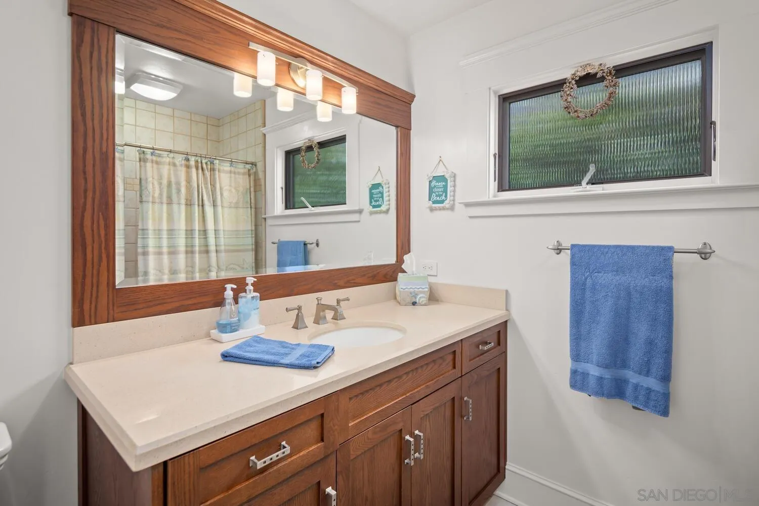 911 B Avenue Coronado, CA 92118 - Photo 28 of 45 a bathroom with a sink and a mirror