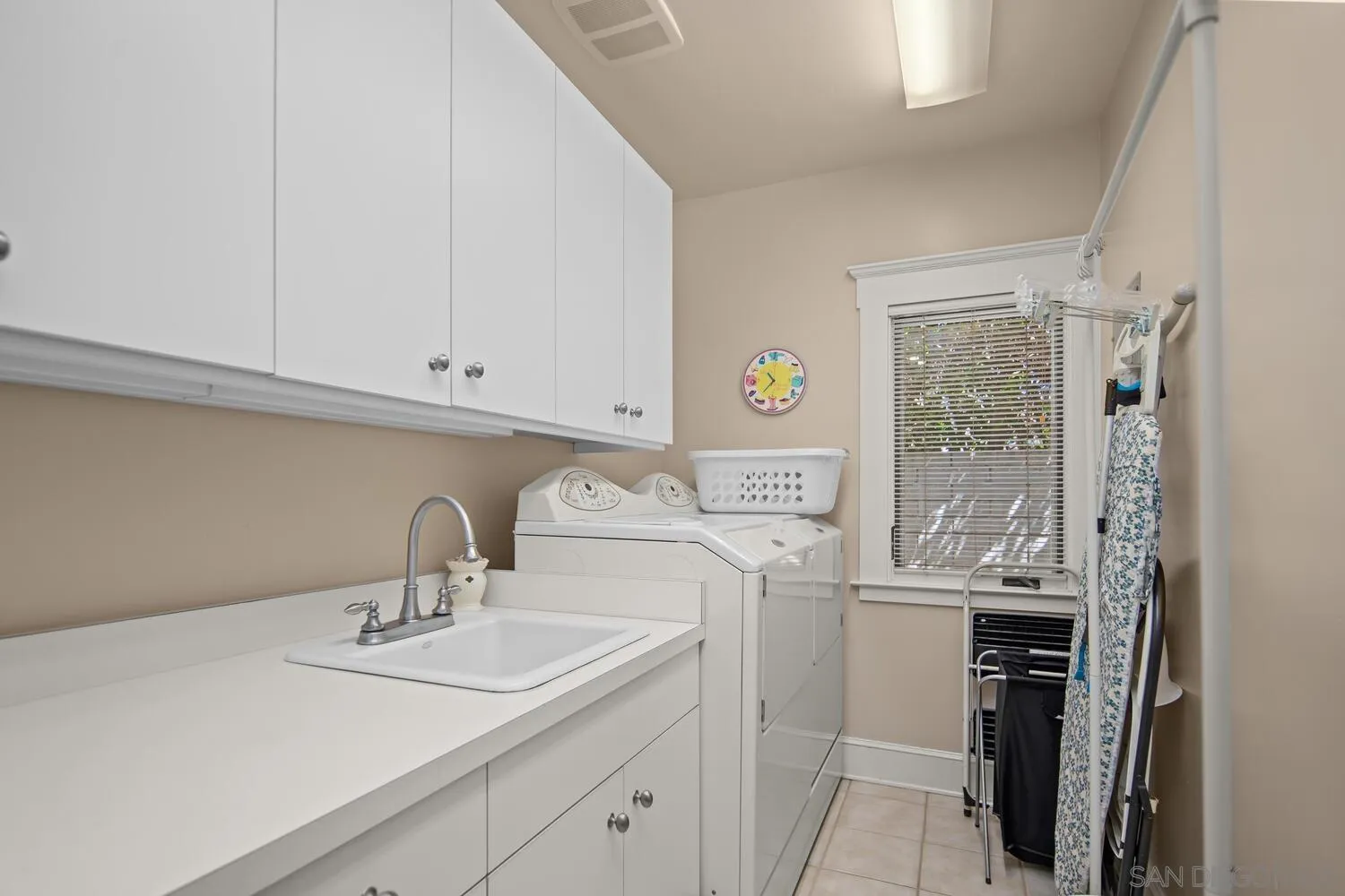 911 B Avenue Coronado, CA 92118 - Photo 29 of 45 a room with a sink a washer and dryer