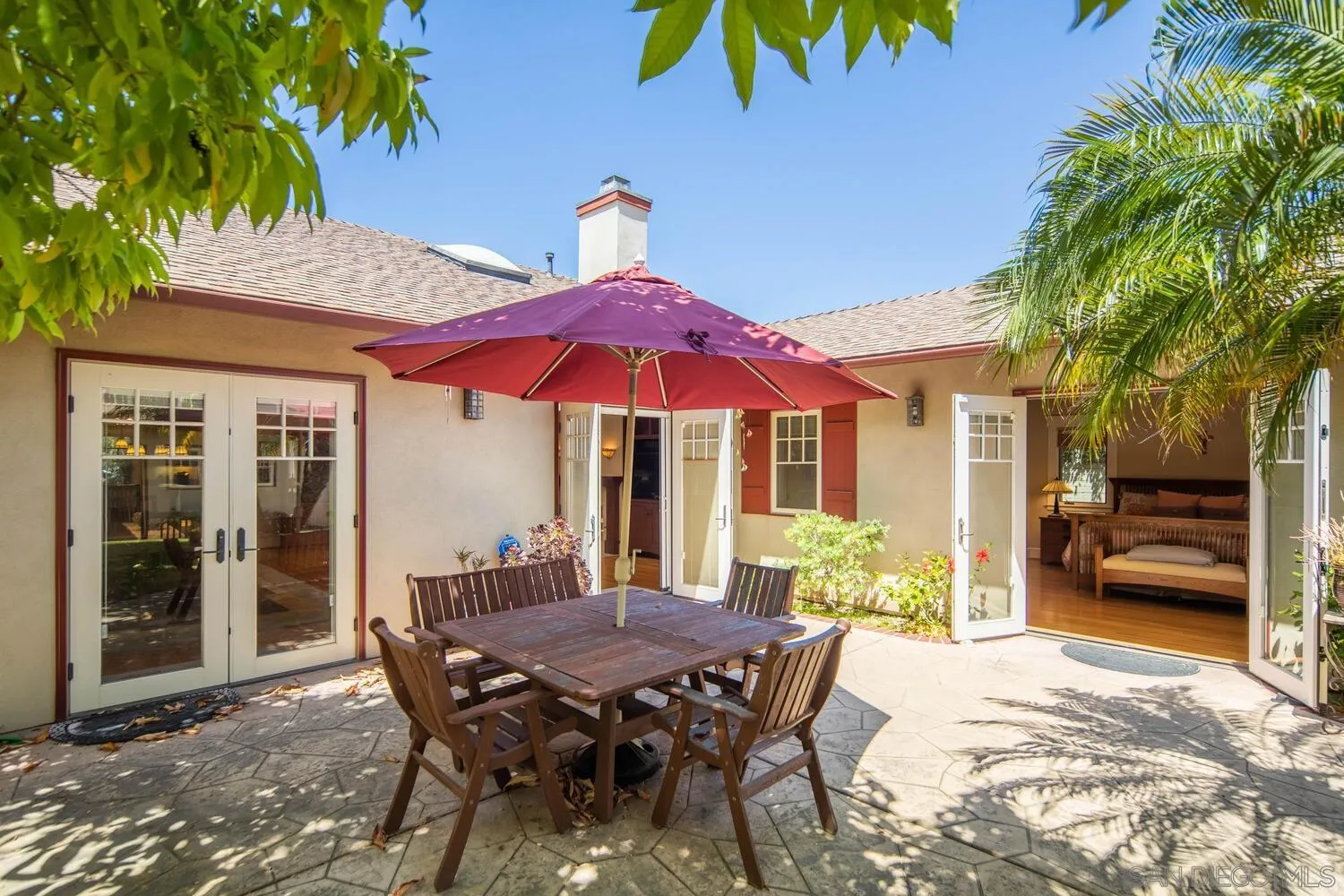 911 B Avenue Coronado, CA 92118 - Photo 30 of 45 a view of a patio with a table and chairs under an umbrella