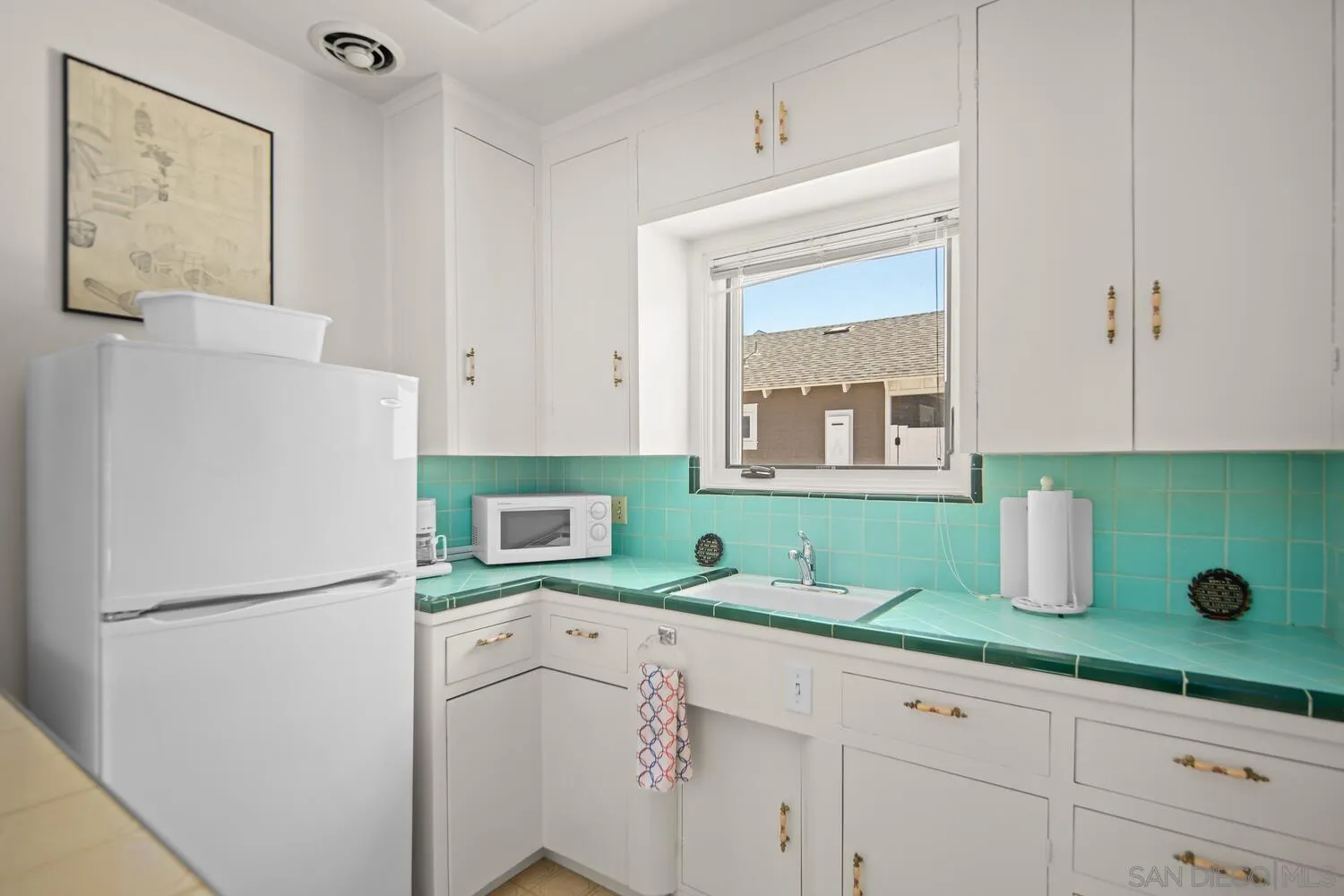 911 B Avenue Coronado, CA 92118 - Photo 41 of 45 a kitchen with a refrigerator and a sink
