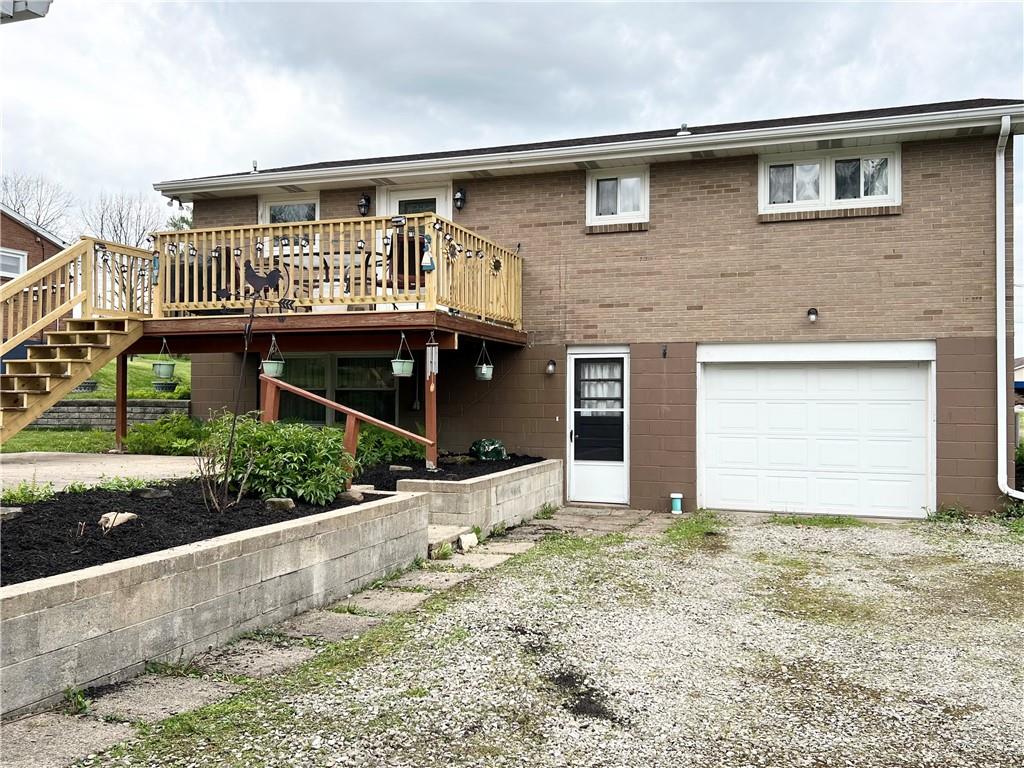 105 Owens View Avenue Apollo, PA 15613 - Photo 26 of 32 Back view of home with integral garage, deck and fresh mulch.