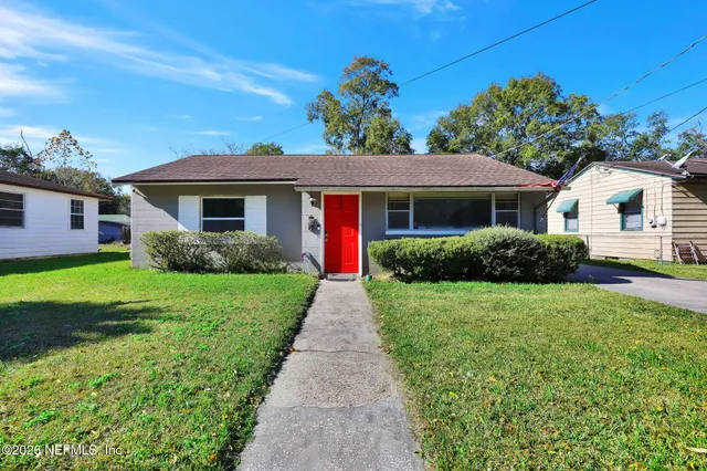 a front view of house with yard and green space