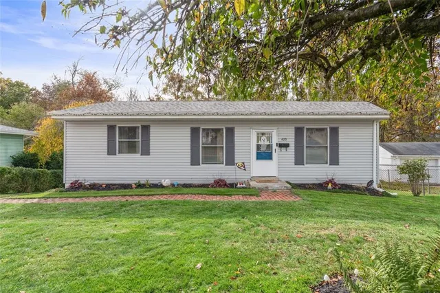 a front view of a house with a garden and yard