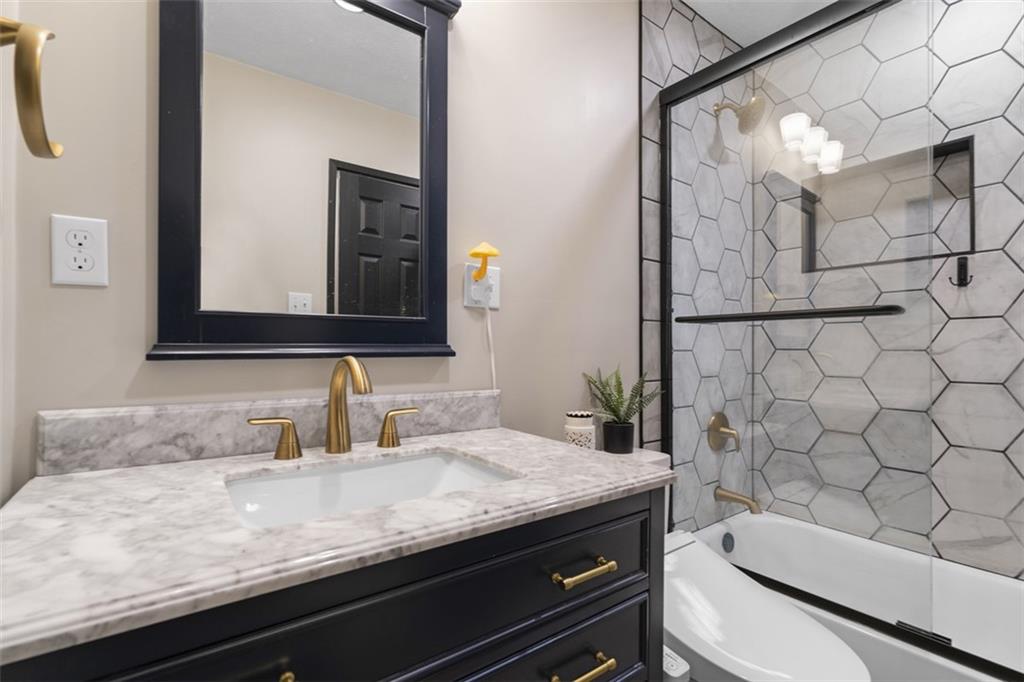 420 Donnell Road Lower Burrell, PA 15068 - Photo 16 of 33 a bathroom with a granite countertop toilet sink and mirror