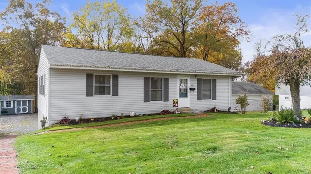 a front view of house with yard and green space