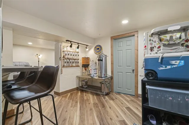 a view of a workspace with furniture and wooden floor