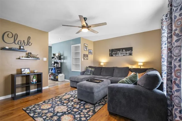 a living room with furniture and wooden floor