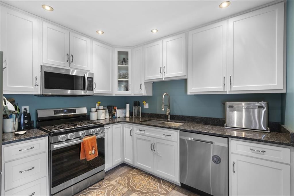 420 Donnell Road Lower Burrell, PA 15068 - Photo 8 of 33 a kitchen with granite countertop white cabinets sink and stainless steel appliances