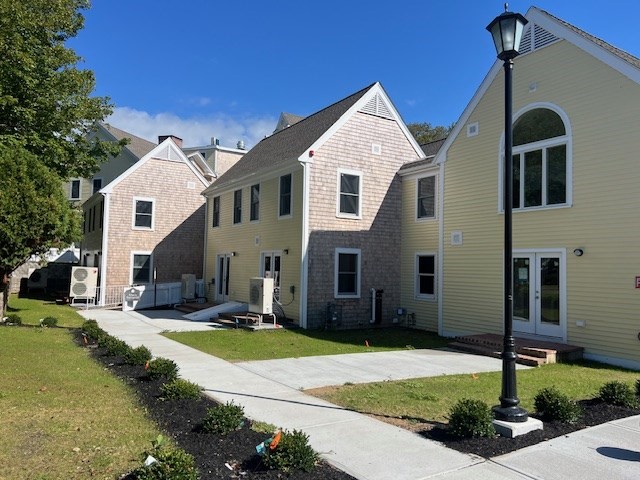 328 Bank Street, Unit 21 Harwich, MA 02645 - Photo 8 of 8 a front view of a house with garden