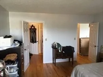 a bedroom with a bed and a mirror