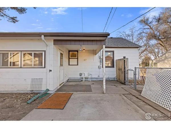 a backyard of a house with table and chairs