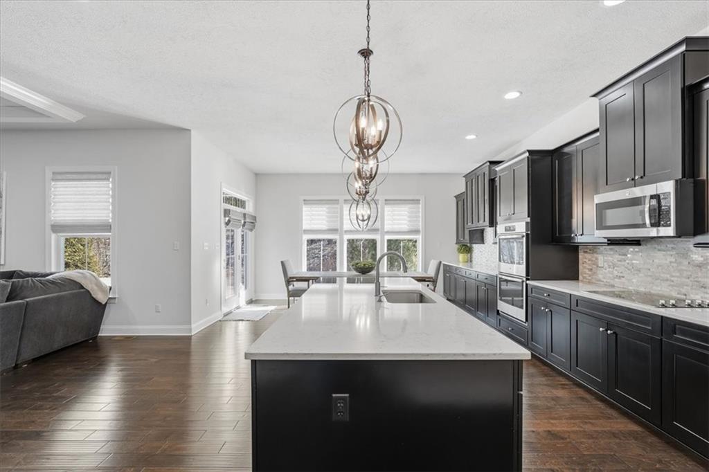 147 Seneca Place Mars, PA 16046 - Photo 12 of 44 a view of a kitchen area kitchen island dining table wooden floor and window