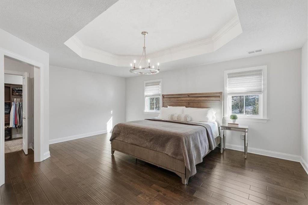 147 Seneca Place Mars, PA 16046 - Photo 20 of 44 a bedroom with a bed and a chandelier