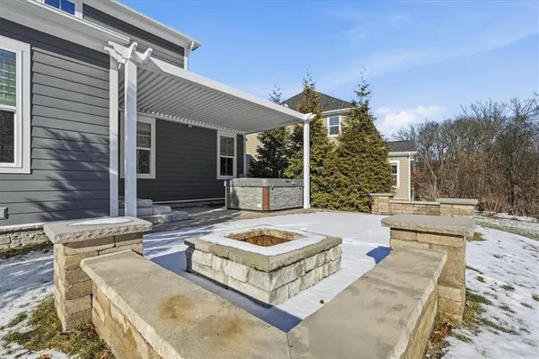 a view of a patio with table and chairs with wooden fence and plants
