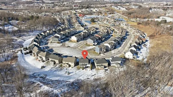 an aerial view of a house with a yard