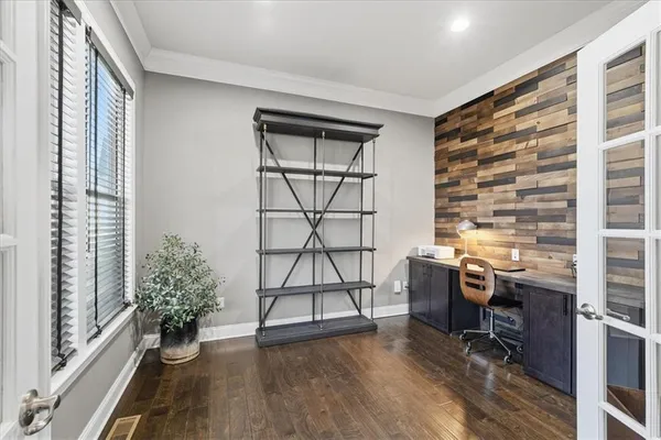 a living room with furniture wooden floor and a flat screen tv