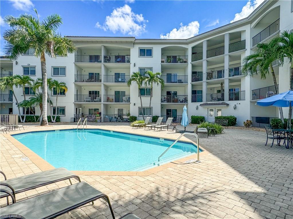 1100 Pine Ridge Road, Unit 307A Naples, FL 34108 - Photo 1 of 4 View of swimming pool featuring a patio