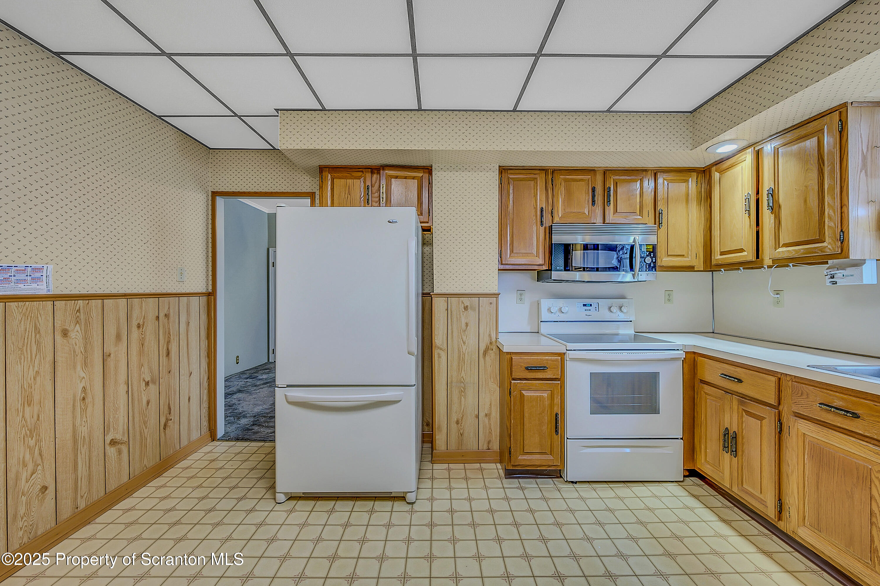 441 14th Avenue Scranton, PA 18504 - Photo 11 of 25 a kitchen with stainless steel appliances a refrigerator sink and microwave