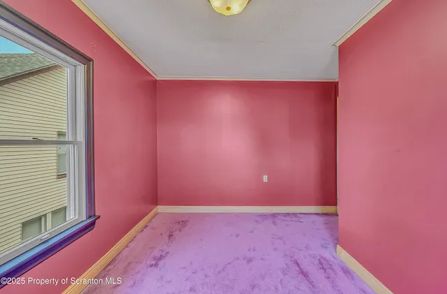 an empty room with windows and closet