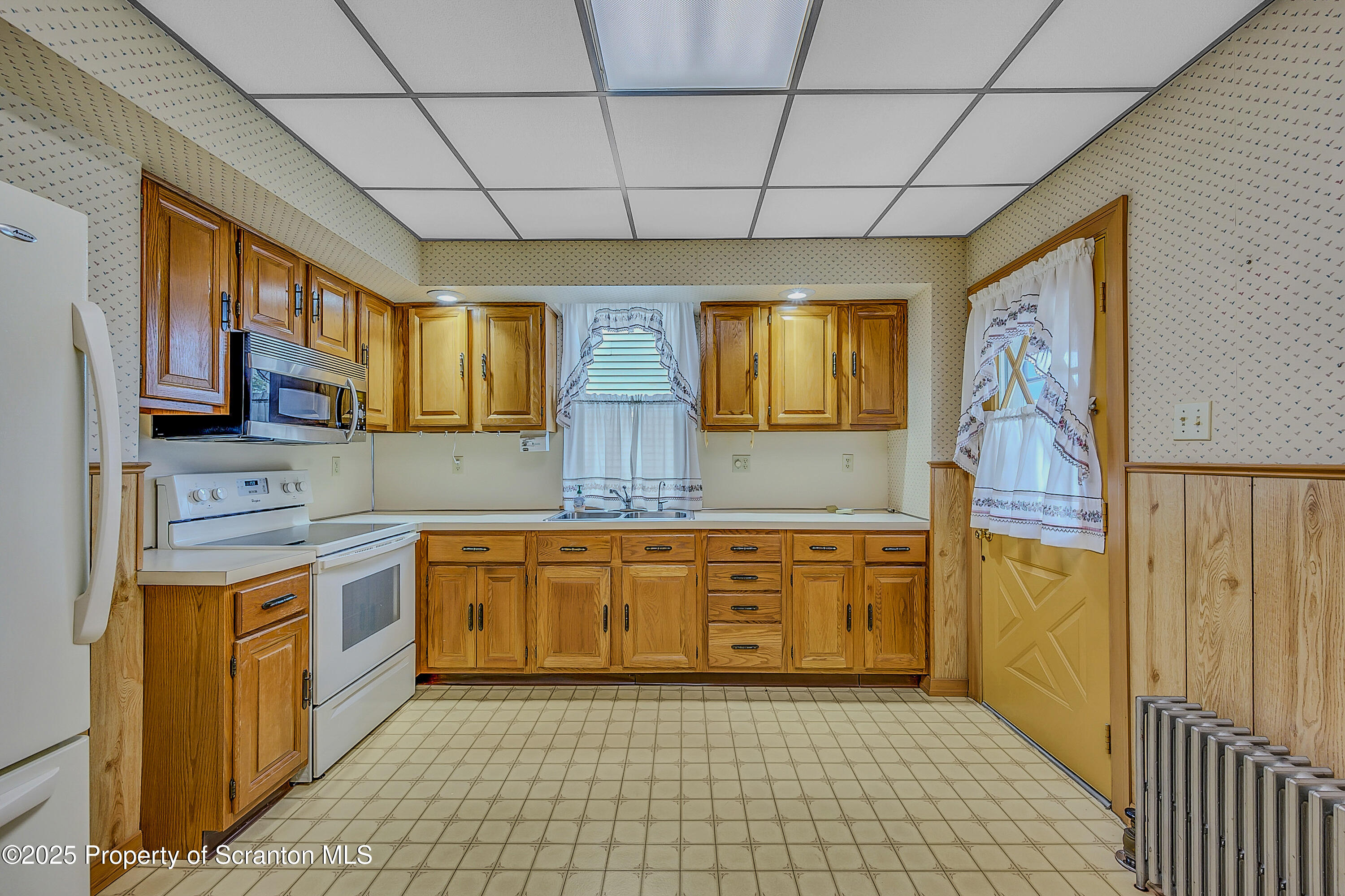 441 14th Avenue Scranton, PA 18504 - Photo 9 of 25 a large kitchen with stainless steel appliances granite countertop a sink and cabinets