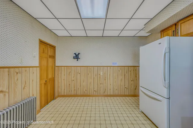 a kitchen with stainless steel appliances a refrigerator sink and microwave