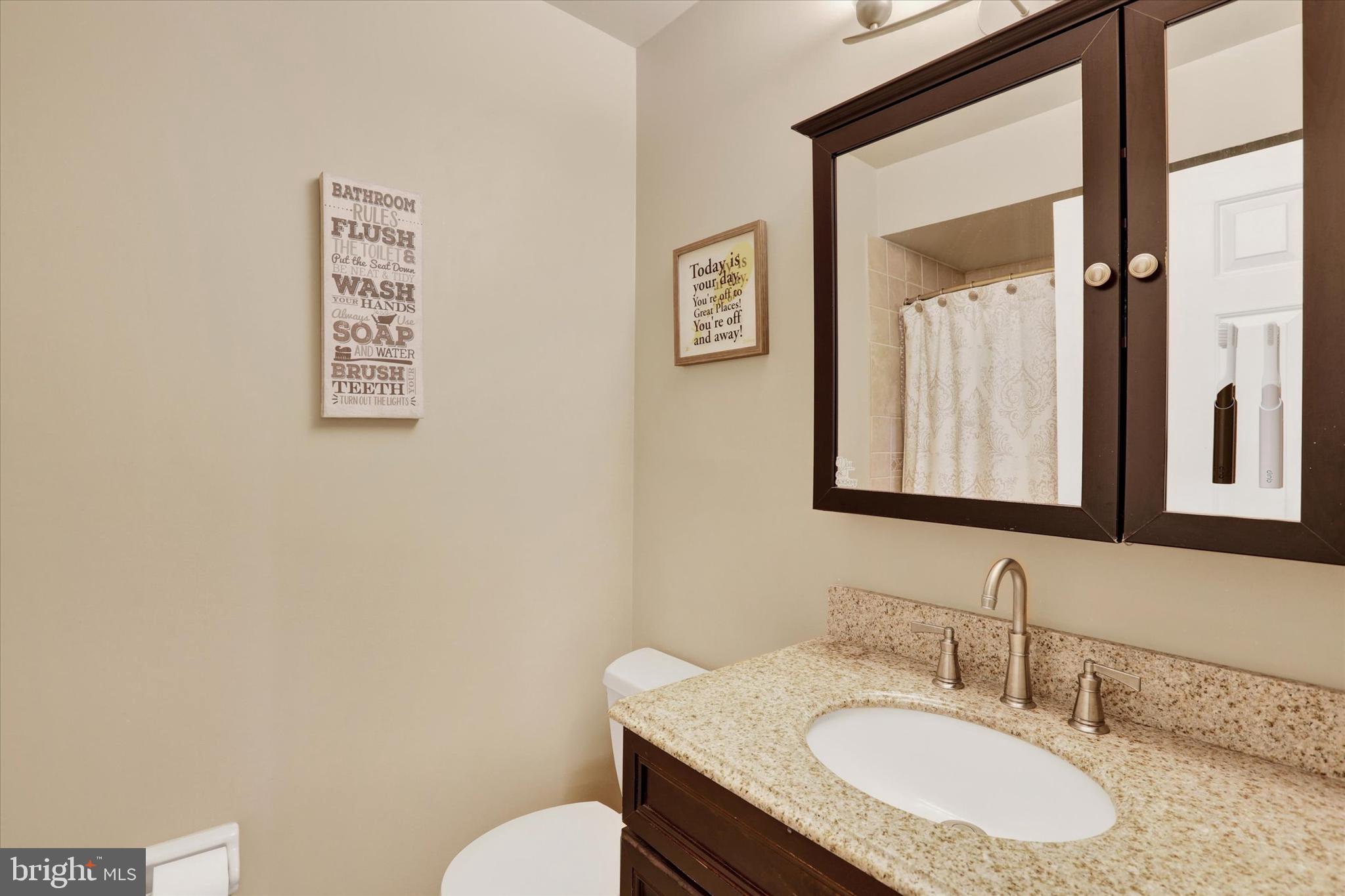 414 Trend Road Yardley, PA 19067 - Photo 29 of 57 a bathroom with a granite countertop sink mirror and toilet