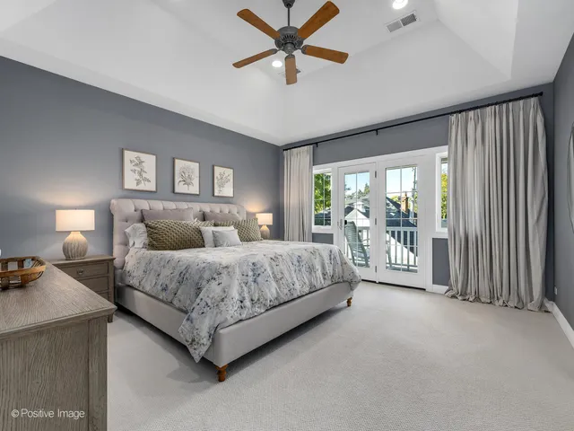 a spacious bedroom with a bed and a large window