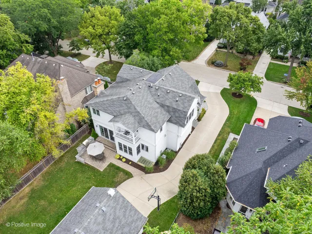 an aerial view of a house with garden space and street view
