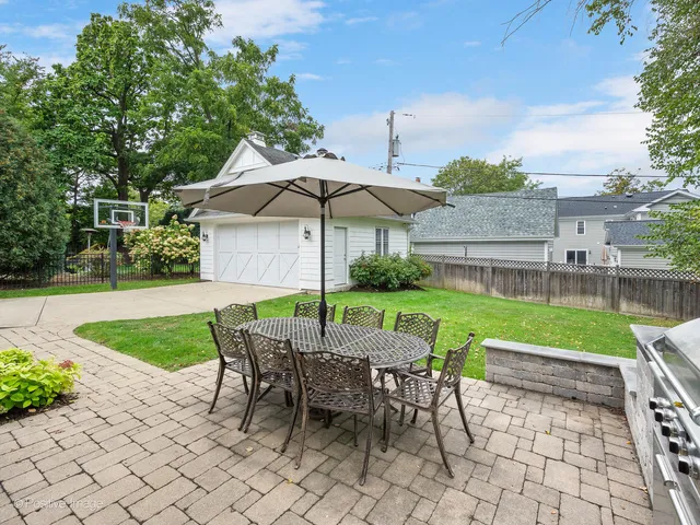 a view of backyard with seating space and plants