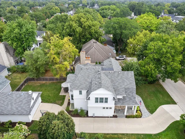 an aerial view of a house with swimming pool and garden