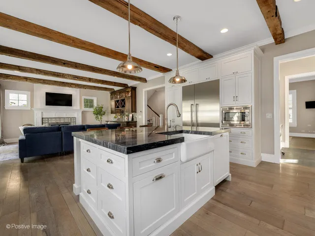 a kitchen with granite countertop a sink and cabinets