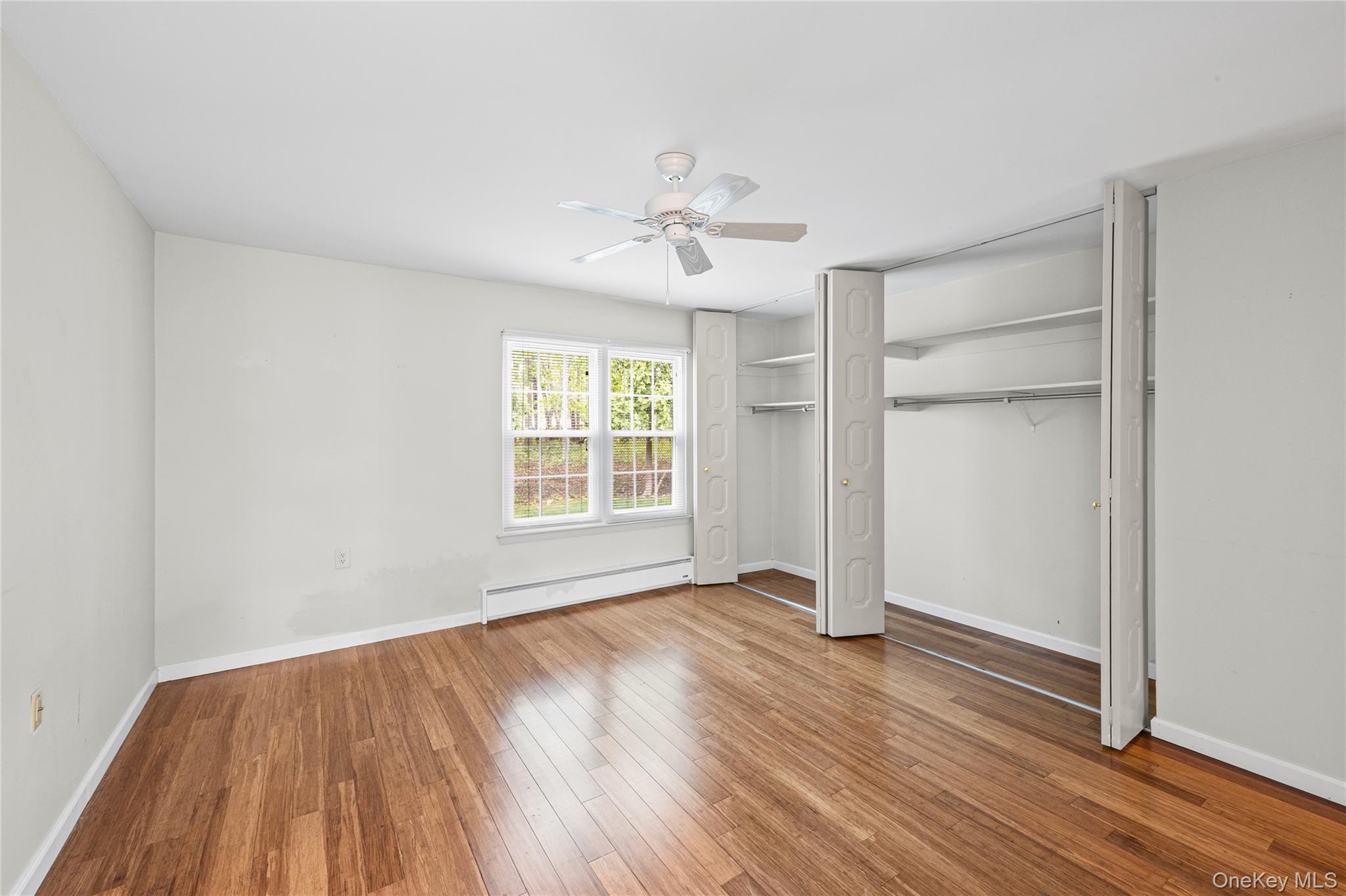 220 Belfast Lane Ridge, NY 11961 - Photo 32 of 44 wooden floor in an empty room with a window