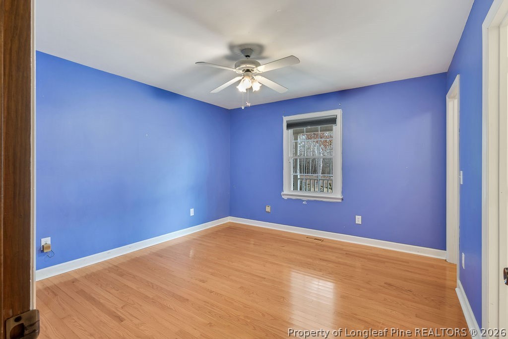 698 Sheriff Watson Road Sanford, NC 27332 - Photo 19 of 41 a view of an empty room with window and a ceiling fan