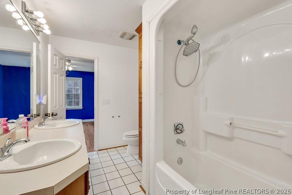698 Sheriff Watson Road Sanford, NC 27332 - Photo 20 of 41 a bathroom with a granite countertop sink a toilet and shower