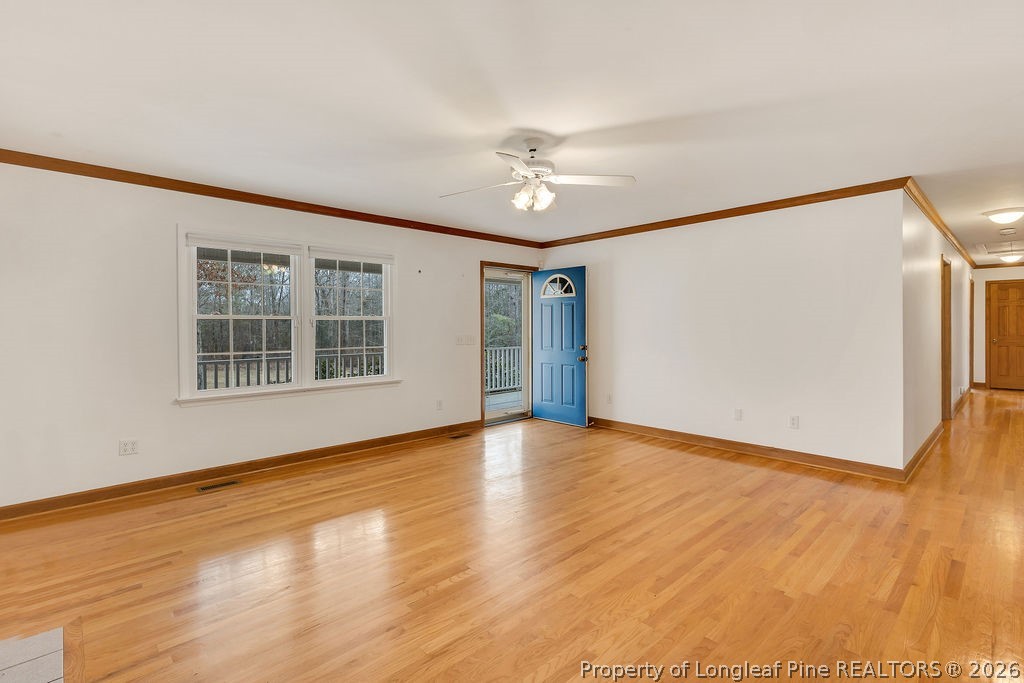 698 Sheriff Watson Road Sanford, NC 27332 - Photo 2 of 41 a view of an empty room with wooden floor and a window