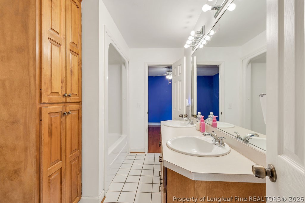 698 Sheriff Watson Road Sanford, NC 27332 - Photo 21 of 41 a bathroom with a sink and a mirror