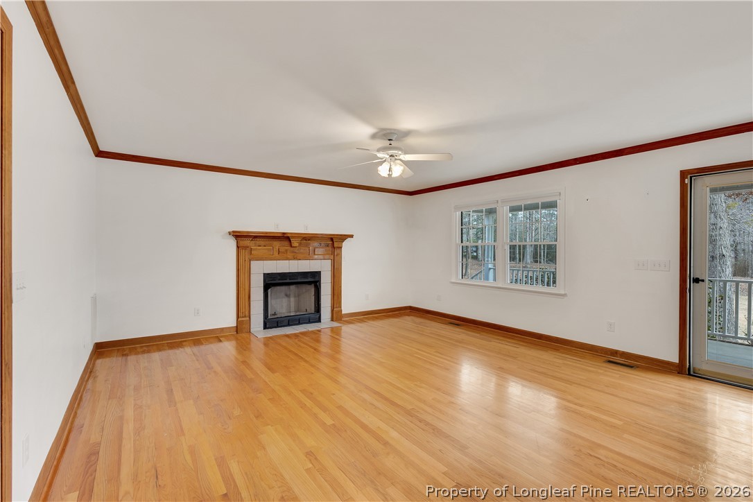 698 Sheriff Watson Road Sanford, NC 27332 - Photo 3 of 41 wooden floor fireplace and windows in an empty room