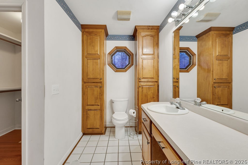 698 Sheriff Watson Road Sanford, NC 27332 - Photo 34 of 41 a bathroom with a granite countertop sink and a mirror