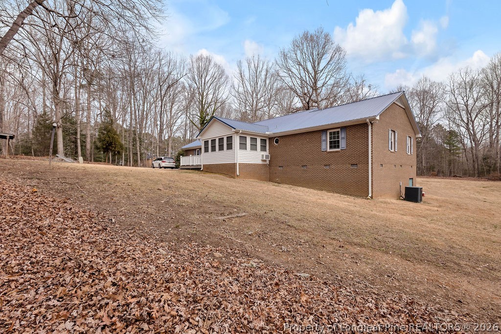 698 Sheriff Watson Road Sanford, NC 27332 - Photo 37 of 41 a front view of a house with a yard and garage