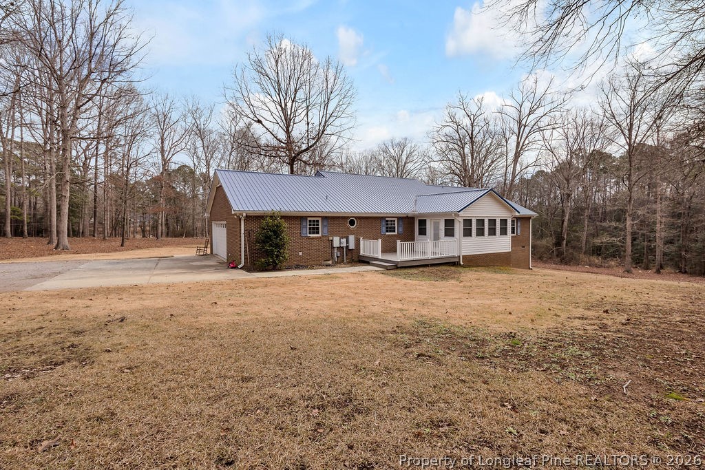 698 Sheriff Watson Road Sanford, NC 27332 - Photo 39 of 41 a front view of a house with a yard and garage