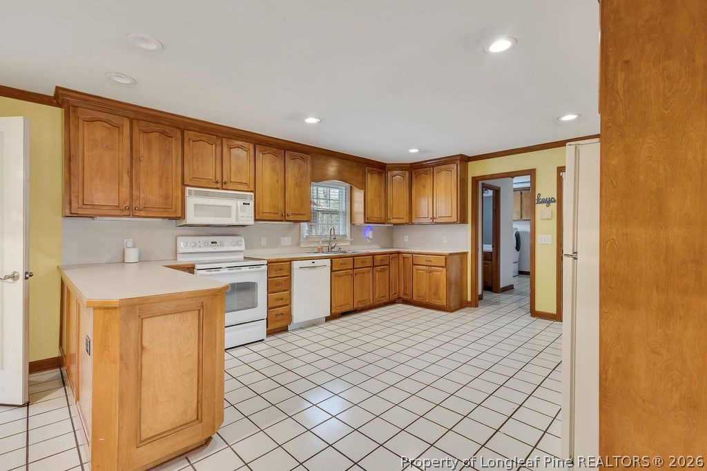 698 Sheriff Watson Road Sanford, NC 27332 - Photo 7 of 41 a kitchen with a refrigerator sink and cabinets