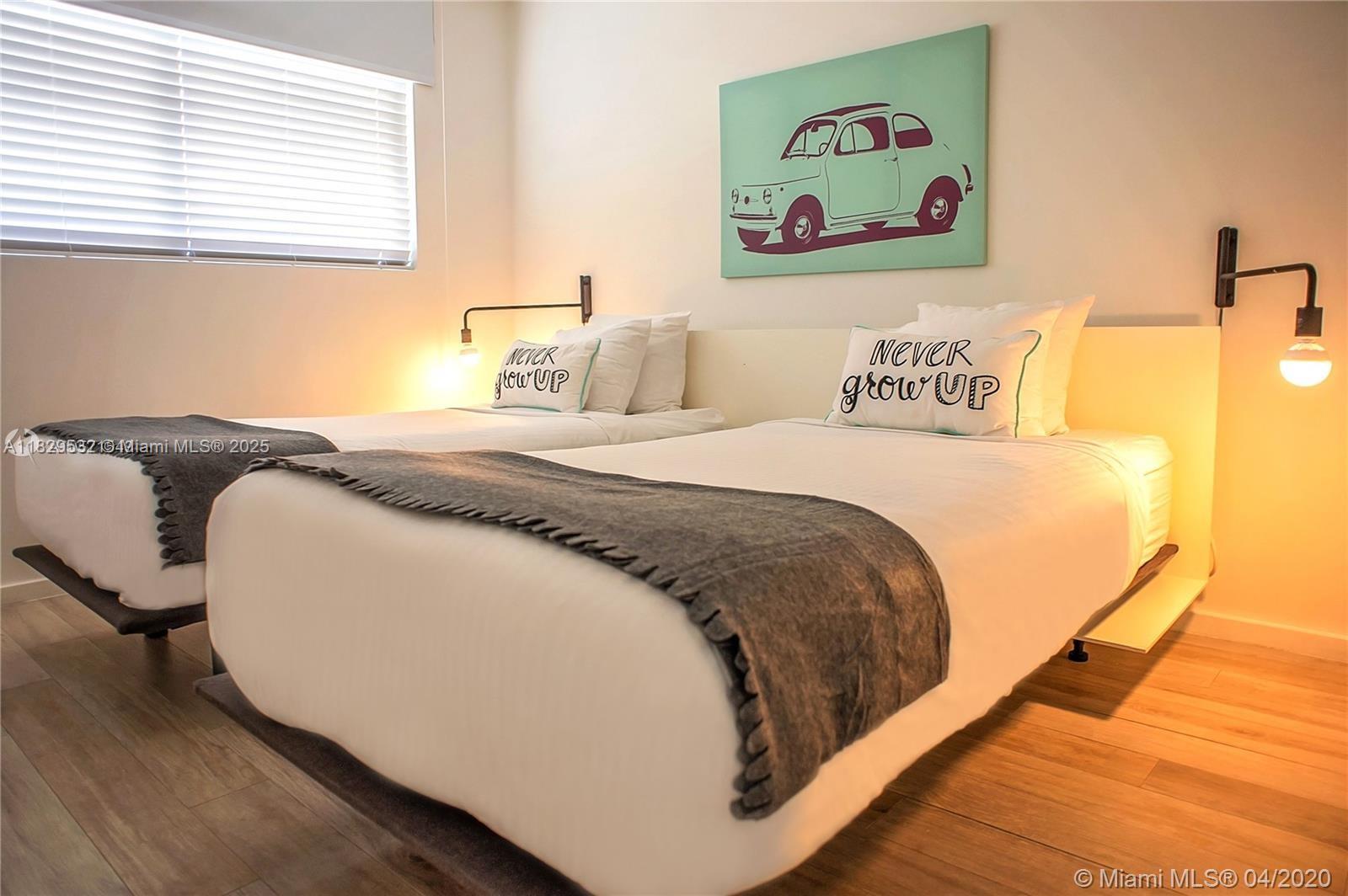 285 Sunrise Drive, Unit 108 Key Biscayne, FL 33149 - Photo 4 of 9 a bed sitting in a bedroom next to a window