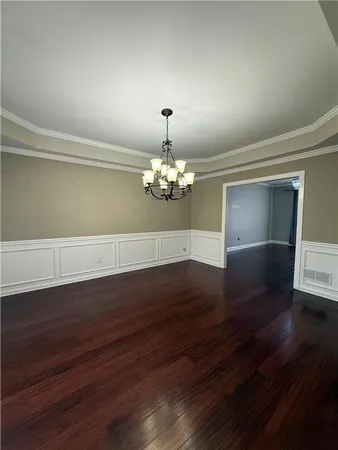 a view of room with hardwood floor and window