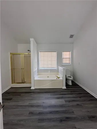 a living room with wooden floor and flat screen tv