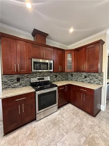 a kitchen with stainless steel appliances granite countertop a stove and a sink